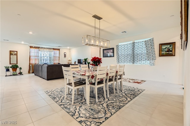 dining space featuring light tile patterned floors, a notable chandelier, visible vents, and recessed lighting