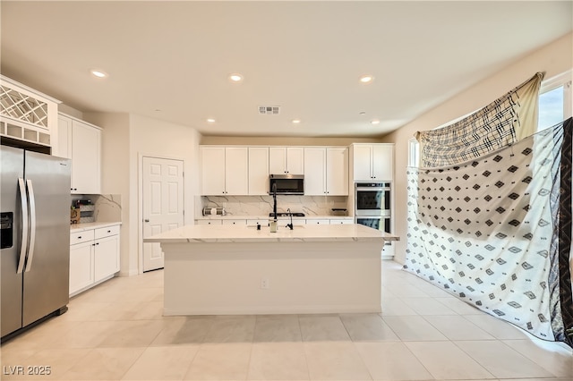 kitchen featuring appliances with stainless steel finishes, visible vents, and white cabinets