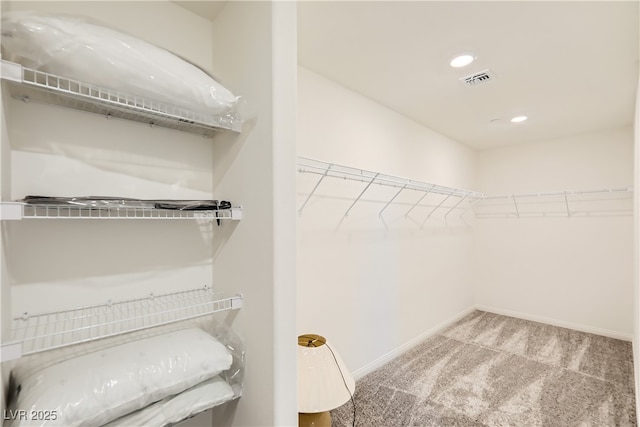 walk in closet featuring carpet and visible vents