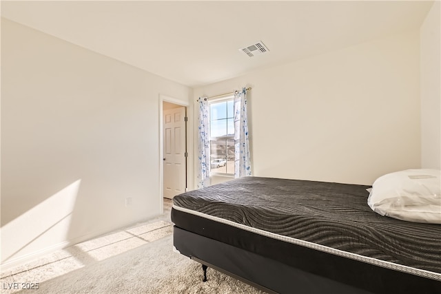 bedroom featuring visible vents and light colored carpet