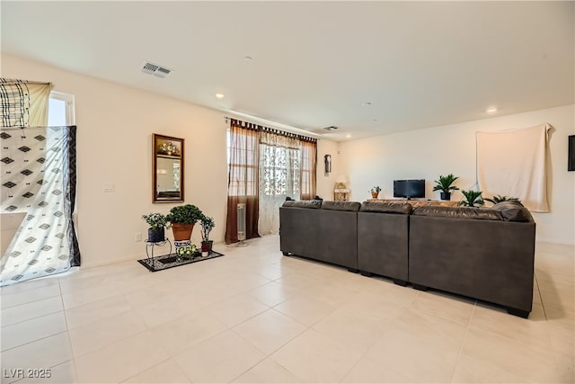 living area with light tile patterned flooring, visible vents, and recessed lighting