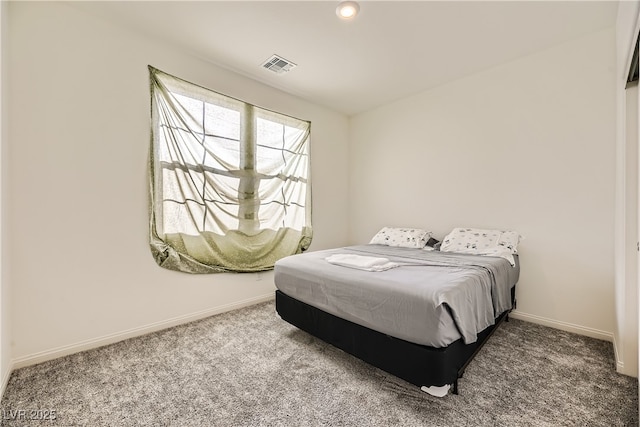 bedroom with carpet floors, visible vents, and baseboards