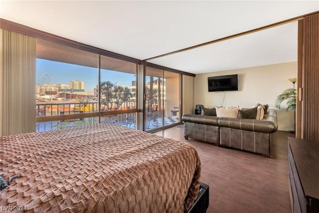 bedroom featuring a wall of windows and access to outside