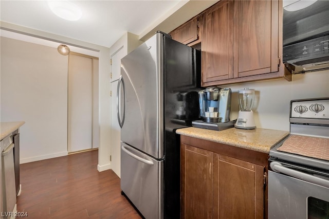 kitchen featuring stainless steel fridge, dark hardwood / wood-style flooring, and electric stove