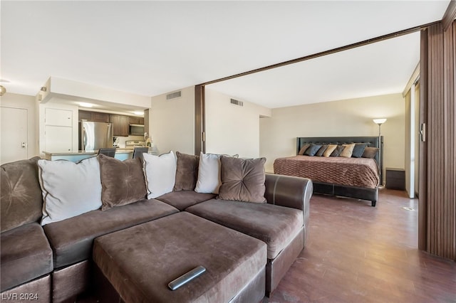 bedroom featuring hardwood / wood-style flooring and stainless steel fridge