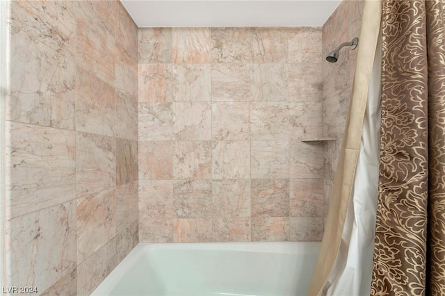 bathroom with shower / bath combination with curtain