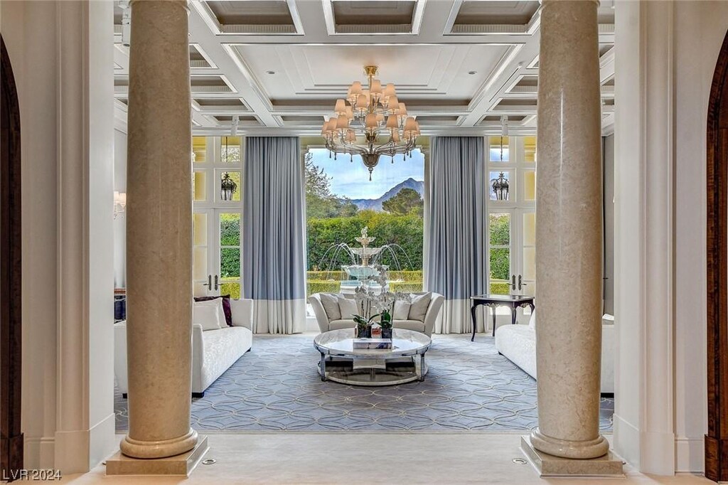 1717 Enclave Ct, Las Vegas, NV 89134 - interior space with ornate columns, beamed ceiling, a chandelier, and coffered ceiling