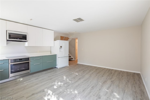 kitchen featuring white cabinetry, light hardwood / wood-style flooring, stainless steel oven, and white fridge with ice dispenser