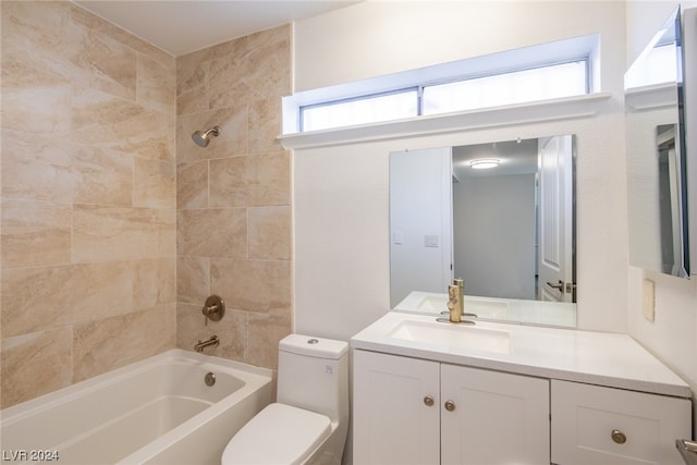 full bathroom featuring tiled shower / bath combo, toilet, and vanity