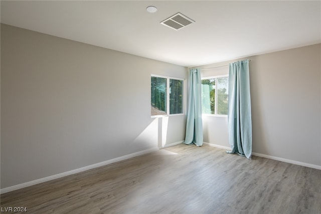 empty room with hardwood / wood-style flooring