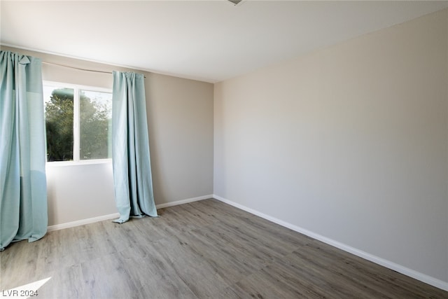 empty room with hardwood / wood-style floors