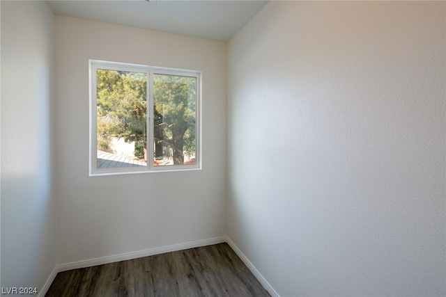 unfurnished room with dark hardwood / wood-style flooring