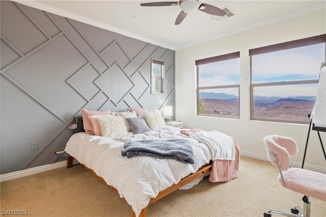 carpeted bedroom with ceiling fan and crown molding