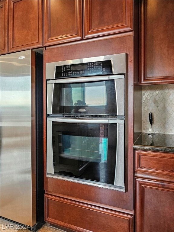 kitchen with stainless steel appliances and backsplash