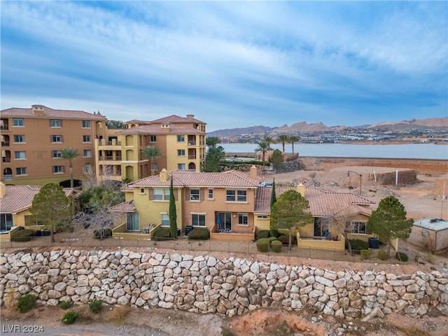 exterior space with a water and mountain view