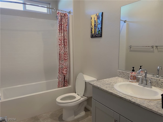 full bathroom with tile flooring, shower / tub combo with curtain, vanity with extensive cabinet space, and toilet