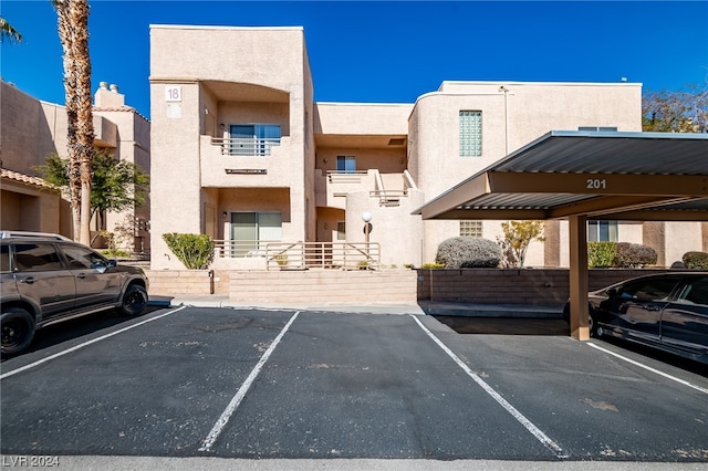 view of vehicle parking with a carport