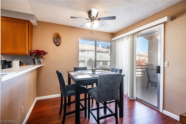 dining space with ceiling fan, dark hardwood / wood-style floors, and a textured ceiling