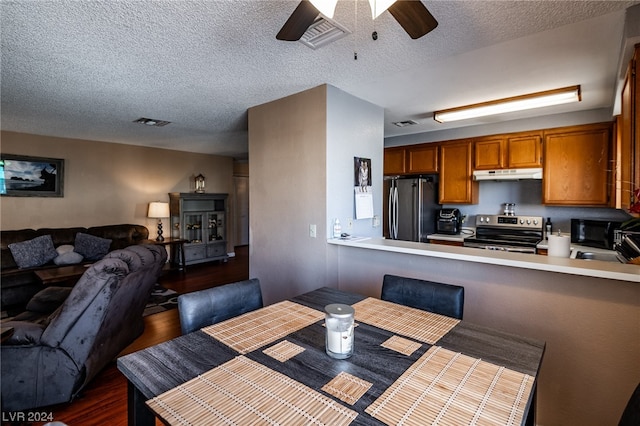 dining room with ceiling fan, dark hardwood / wood-style flooring, sink, and a textured ceiling