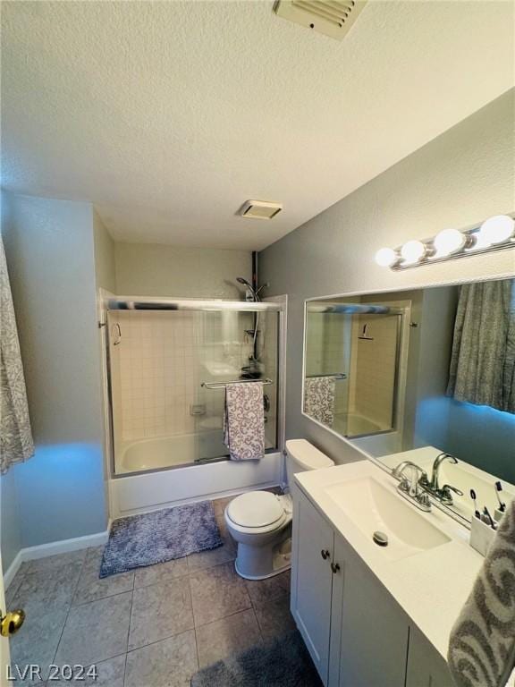 full bathroom with enclosed tub / shower combo, vanity, a textured ceiling, tile patterned floors, and toilet