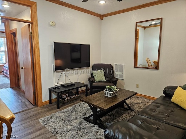 living room featuring ornamental molding, wood-type flooring, and heating unit