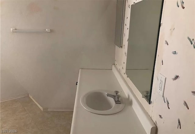 bathroom with vanity and tile flooring