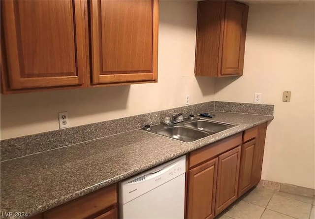 kitchen featuring light tile floors, dishwasher, and sink