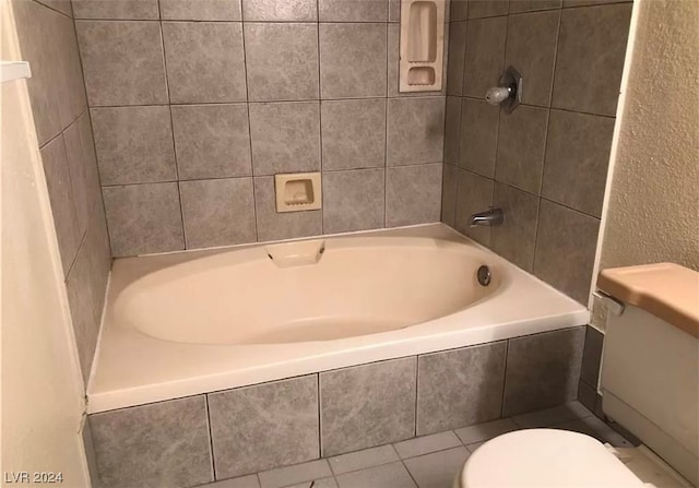 bathroom with toilet and tile floors