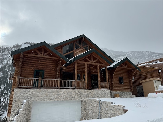 log home featuring a mountain view and a garage