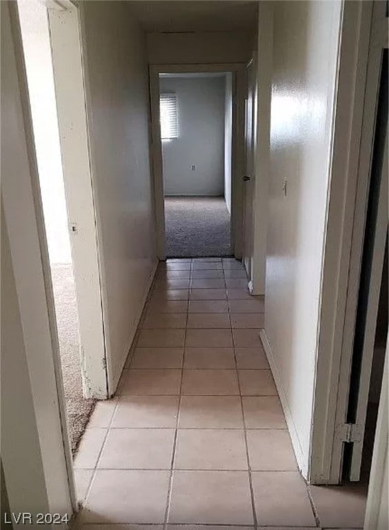 hallway featuring light tile flooring