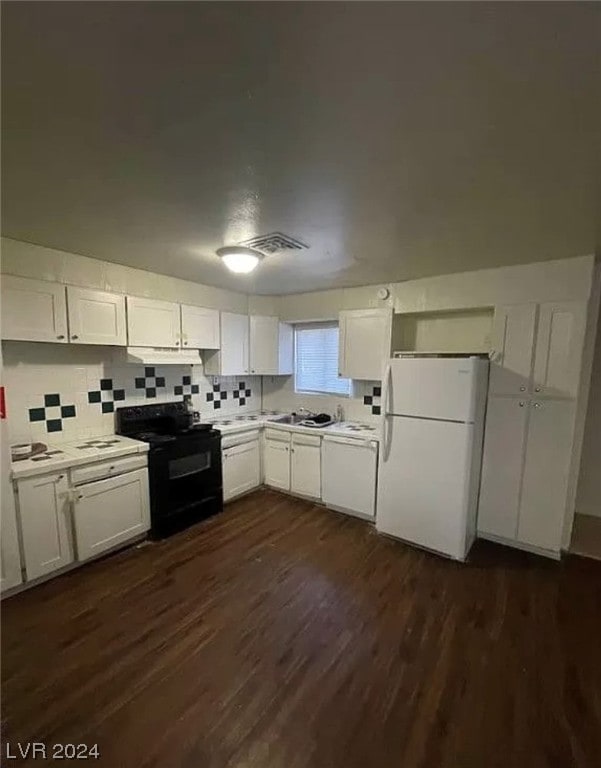 kitchen with white fridge, electric range, dark hardwood / wood-style floors, white cabinets, and tasteful backsplash