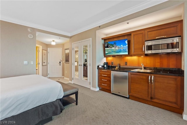 bedroom with sink, refrigerator, french doors, and ornamental molding