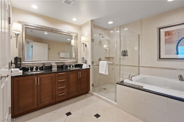 bathroom with tile patterned floors, vanity, and independent shower and bath