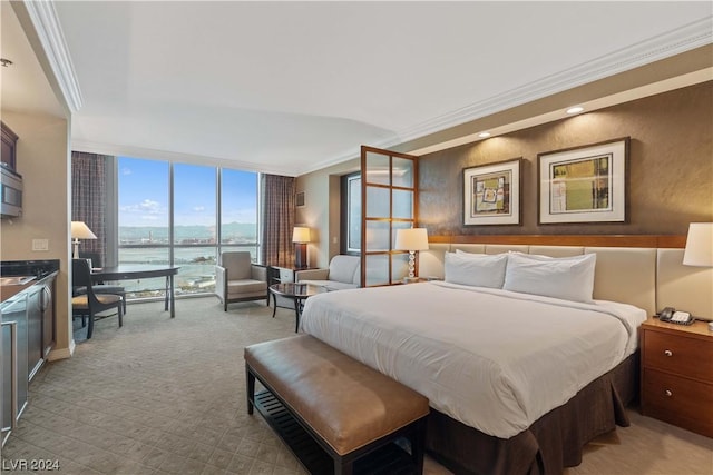 carpeted bedroom featuring a water view, ornamental molding, and a wall of windows