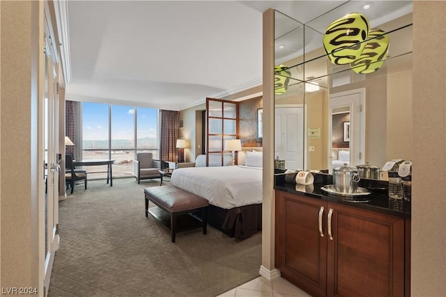 bedroom with floor to ceiling windows and light colored carpet