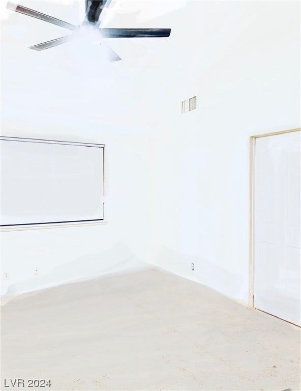 spare room with ceiling fan and concrete flooring