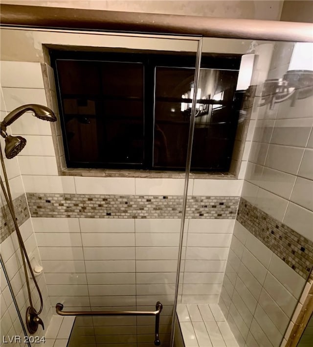 bathroom with a tile shower