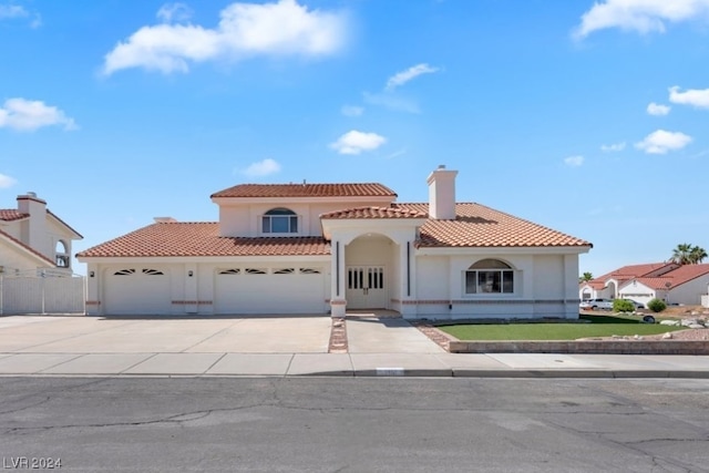 mediterranean / spanish house with a garage