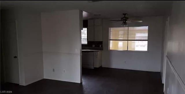 kitchen with ceiling fan and white cabinetry