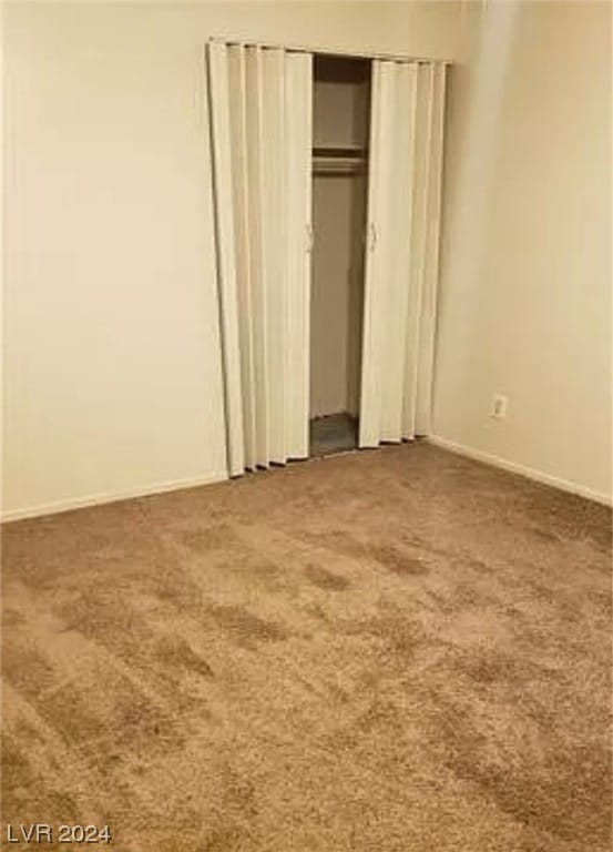 unfurnished bedroom featuring a closet and carpet