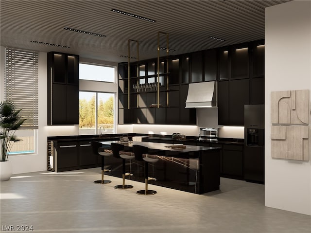 kitchen featuring stainless steel fridge, sink, a high ceiling, and wall chimney range hood