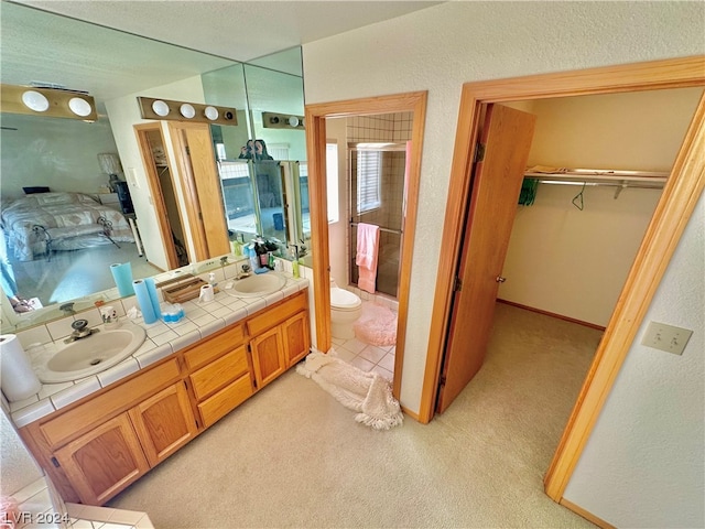 bathroom featuring vanity, tile patterned flooring, and toilet