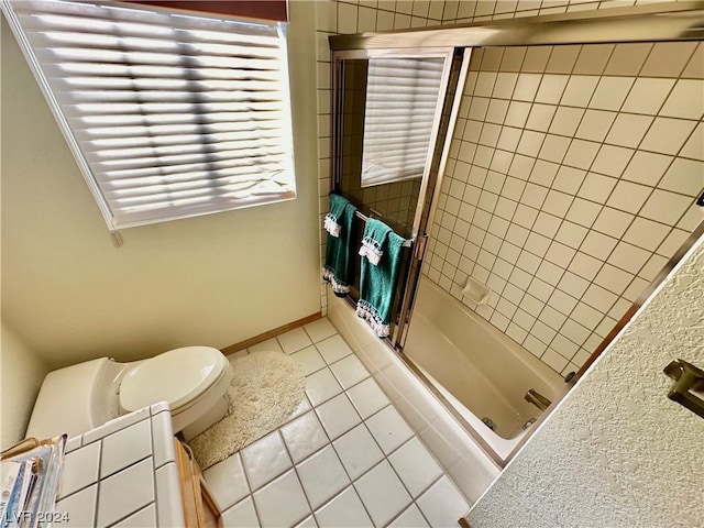 full bathroom with tile patterned flooring,  shower combination, toilet, and baseboards