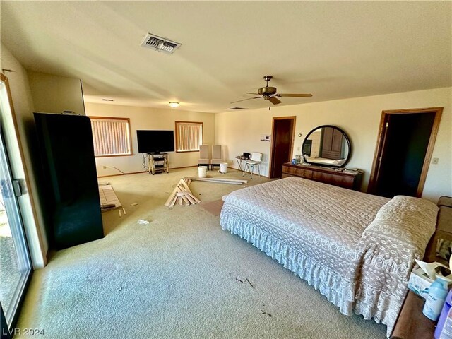 bedroom with ceiling fan and light colored carpet