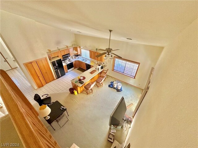 tiled living room featuring high vaulted ceiling and ceiling fan