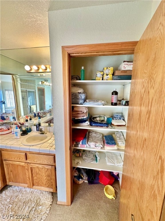 bathroom with vanity and a textured ceiling