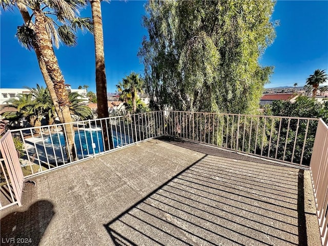 wooden terrace featuring a fenced in pool and a patio area