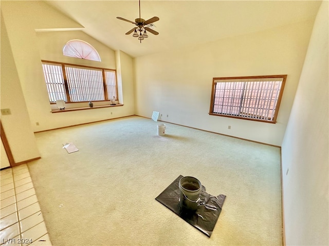 spare room featuring baseboards, high vaulted ceiling, a ceiling fan, and carpet