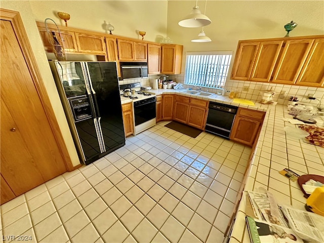 kitchen with black appliances, a sink, tile countertops, light tile patterned flooring, and decorative backsplash