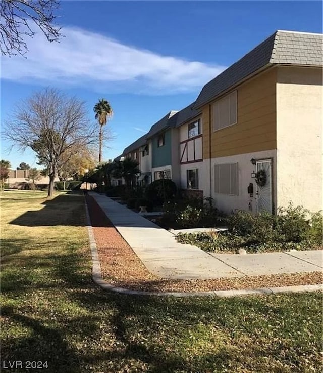 view of property exterior featuring a lawn